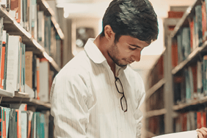 - a close up of a young man in a library