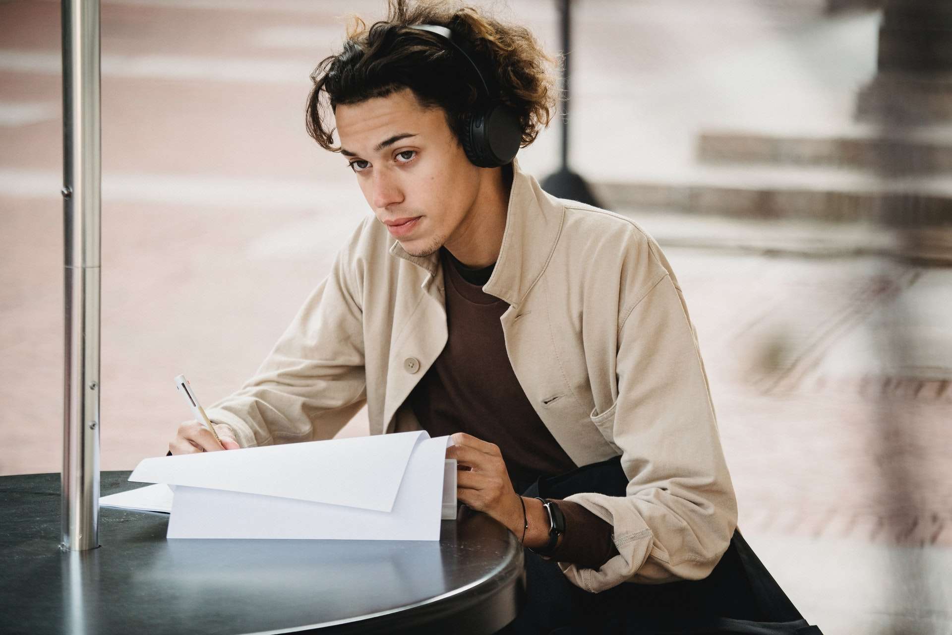 A Student Learning With Headphones On At The Campus